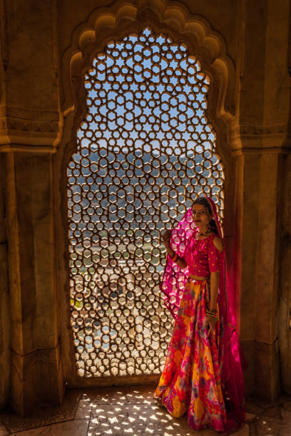 istock Young Indian woman looking through a window 1435344418