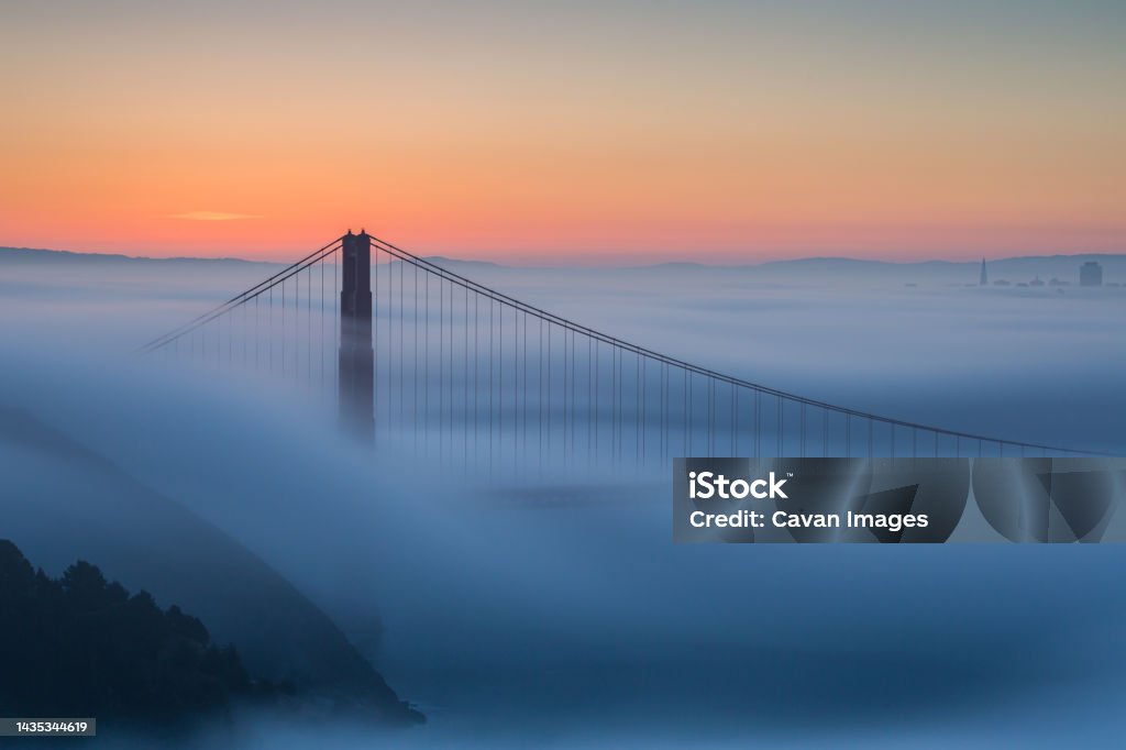 Foggy Sunrise Golden Gate Bridge San Francisco Foggy Sunrise Golden Gate Bridge San Francisco in San Francisco, California, United States San Francisco - California Stock Photo