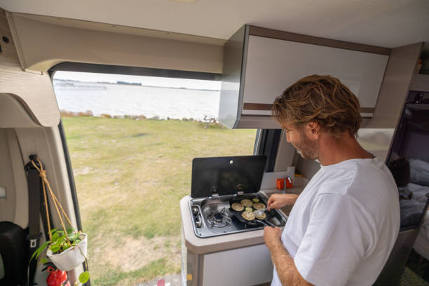 istock Living the van life, young man inside camper van cooking 1435344931