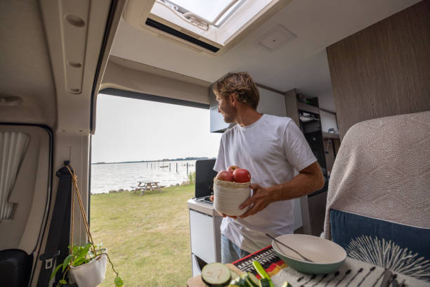 istock Living the van life, young man inside camper van cooking 1435345727