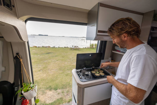 istock Living the van life, young man inside camper van cooking 1435346535