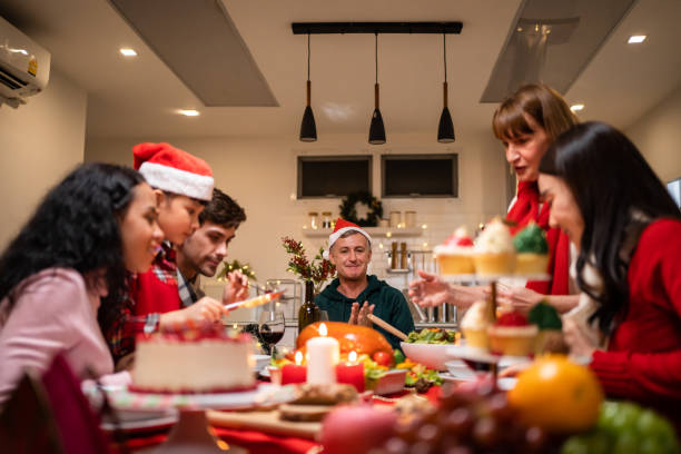 istock Multi-ethnic big family celebrating Christmas party together in house. Attractive diverse group of people having dinner eating food to celebrate holiday Thanksgiving, X-mas eve on dining table at home 1435347310