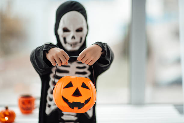 portrait of candid authentic gen z boy have fun in skeleton costume at halloween holiday - human skeleton halloween skull human bone imagens e fotografias de stock