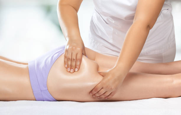 Masseur makes anti-cellulite massage on the legs, thighs, hips and buttocks in the spa. Overweight treatment, body sculpting.Cosmetology and massage concept. stock photo