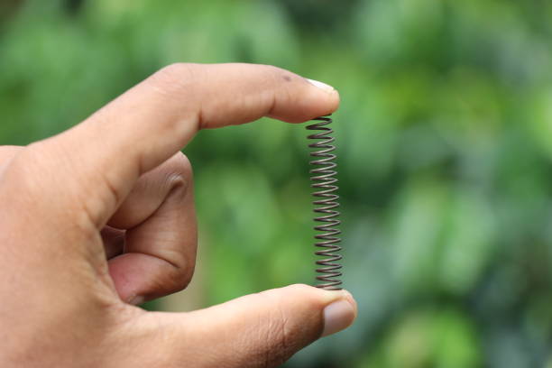 Metal compression springs used to absorb shock on various mechanical moving parts held in hand