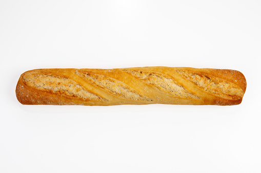Freshly baked quality baguette on white background top view