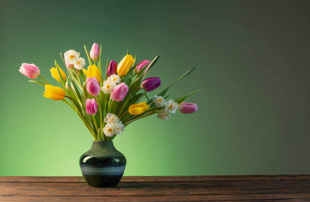 istock spring flowers in  ceramic vase on wooden table 1435351792