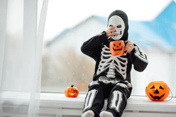 portrait of candid authentic gen z boy have fun in skeleton costume at halloween holiday - human skeleton halloween skull human bone imagens e fotografias de stock