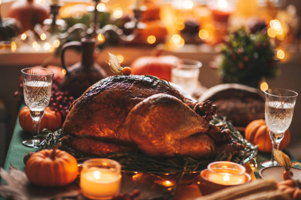 istock Thanksgiving holiday dinner table setting with fall decoration and pumpkins 1435352319