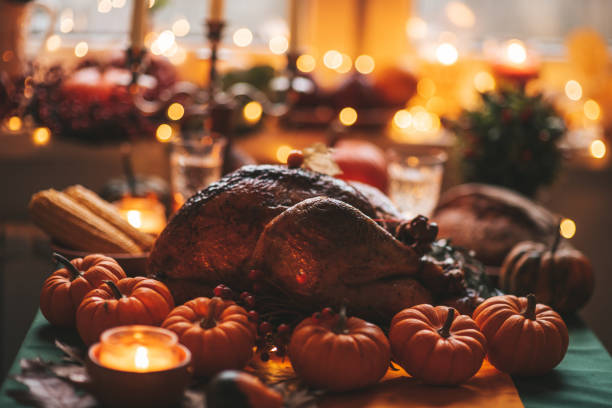 istock Thanksgiving holiday dinner table setting with fall decoration and pumpkins 1435352356