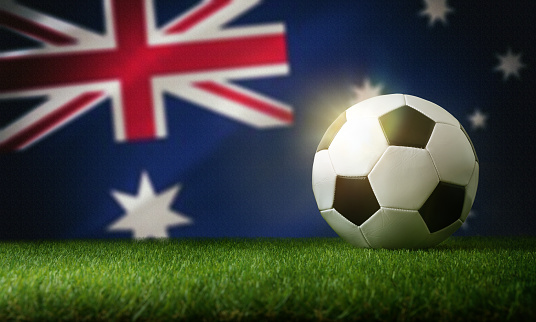 Australia national team composition with classic ball on grass and flag in the background. Front view.
