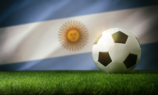 Argentina national team composition with classic ball on grass and flag in the background. Front view.