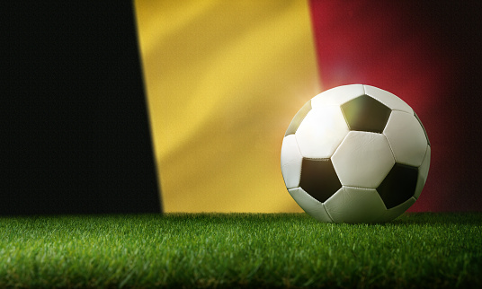 Belgium national team composition with classic ball on grass and flag in the background. Front view.