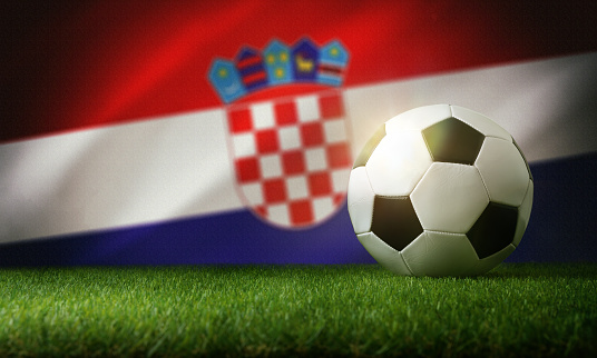 Croatia national team composition with classic ball on grass and flag in the background. Front view.