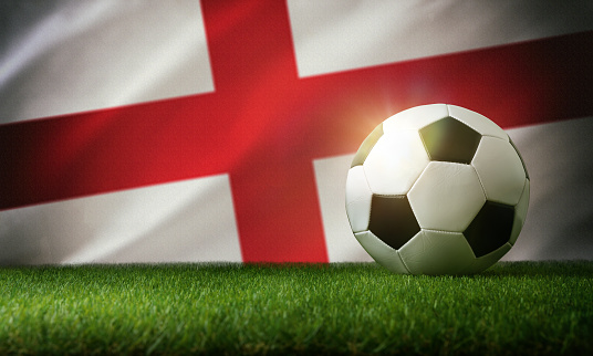England national team composition with classic ball on grass and flag in the background. Front view.