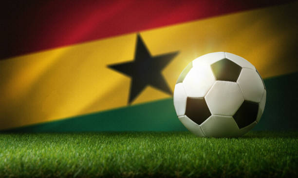 istock Ghana national team background with ball and flag 1435352821