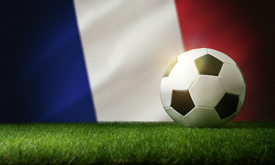 France national team composition with classic ball on grass and flag in the background. Front view.