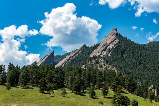 The Flatiron Range near Boulder, Colorado. The image shows a hiking trail leading to the rock formations.