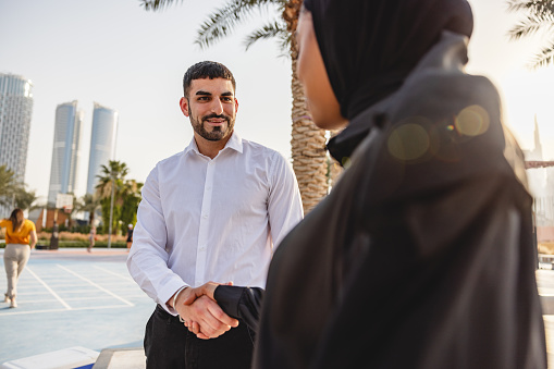 A Young Middle Eastern Business Professional Outside Of Work Shaking hands In Dubai.