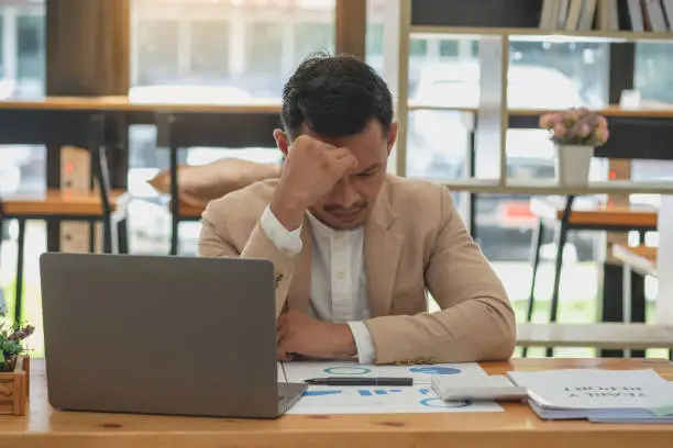 Photo of Concept Burnout Syndrome. Business Woman feels uncomfortable working. Which is caused by stress, accumulated from unsuccessful work And less resting body. Consult a specialist psychiatrist.