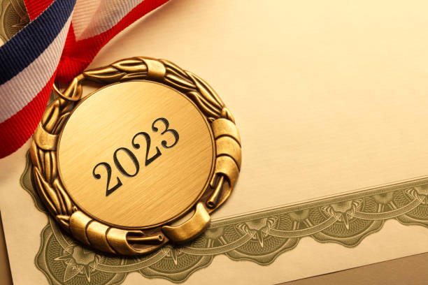 istock Gold Medal Inscribed With 2023 Resting On Award Certificate 1435360077