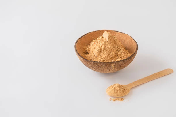 istock Bowl of maca root powder with spoon on white background with copy space 1435362509