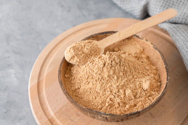 istock Dietary supplement - maca root powder in a bowl on neutral gery background with copy space. 1435362532