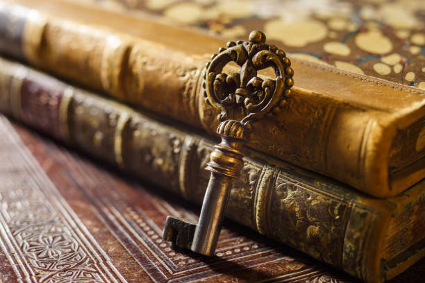 Antique bronze key with patina on ancient books stock photo