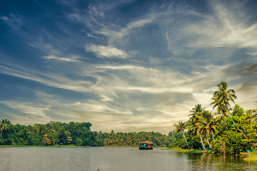 Houseboat navigating on the Kerala Backwaters in South India.