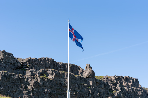 View of the beautiful Iceland Flag waving its beautiful Red, white and blue colors in the Thingvellir National Park