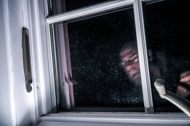 istock Creepy Old Peeping Tom Sneaking Outside Night Window 1435371546