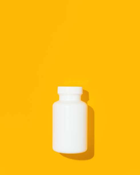 istock Blank white bottle plastic tube on yellow background, flat lay. Space for text. Mockup. 1435371912
