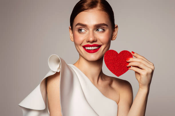 istock Beautiful emotional woman holding present box 1435377421