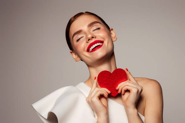 istock Beautiful emotional woman holding present box 1435377452