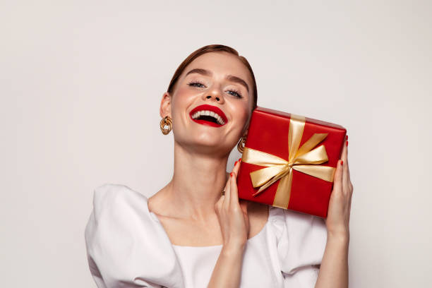 istock Beautiful emotional woman holding present box 1435377693