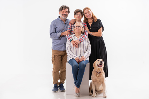 Portrait of happy extended family together with their dog isolated on white background