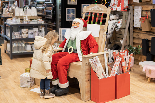 Girl and santa claus in a shop