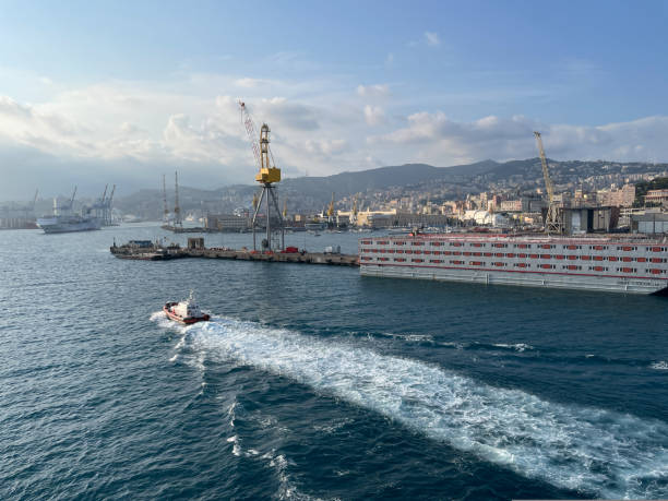 wide panoramic view of the harbor of Genoa. Blue sky blue sea white clouds and port buildings in harmony with the surrounding Mediterranean landscape wide panoramic view of the harbor of Genoa. Blue sky blue sea white clouds and port buildings in harmony with the surrounding Mediterranean landscape High quality photo merchants gate stock pictures, royalty-free photos & images