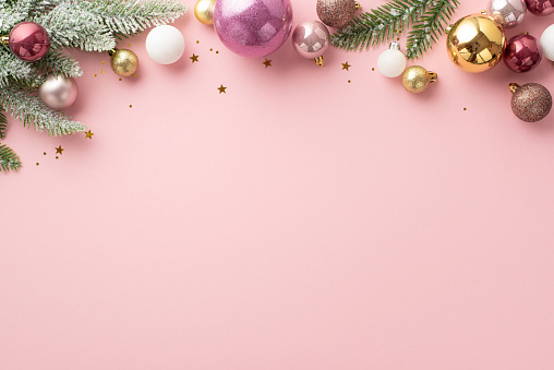 New Year concept. Top view photo of stylish white violet gold and pink baubles confetti and pine branches in snow on isolated light pink background with copyspace