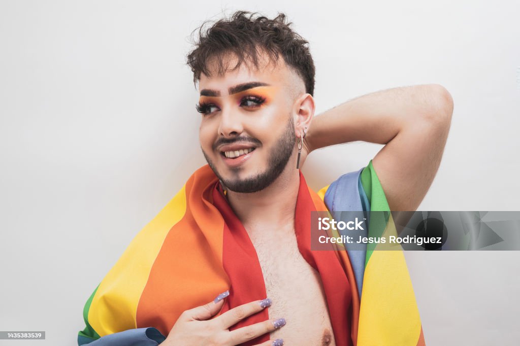 A non-binary person posing with an LGBTI flag. 20-29 Years Stock Photo