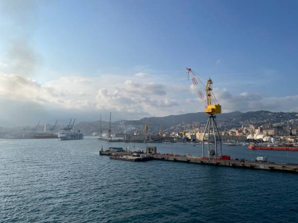 wide panoramic view of the harbor of Genoa. Blue sky blue sea white clouds and port buildings in harmony with the surrounding Mediterranean landscape wide panoramic view of the harbor of Genoa. Blue sky blue sea white clouds and port buildings in harmony with the surrounding Mediterranean landscape High quality photo merchants gate stock pictures, royalty-free photos & images