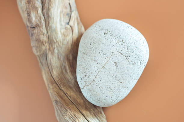istock Mockup composition for advertising made with stones and weathered snag on a sandy background with copy space. 1435385084