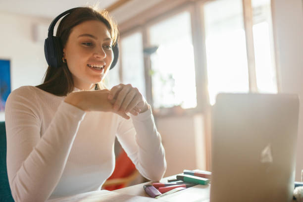 istock Young adult student watching class and learning online at home 1435385623
