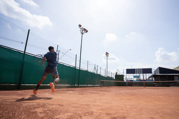 istock young man playing tennis 1435388110
