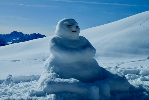 Buddha snowman in the Austrian Alps. Vorarlberg, Austria.