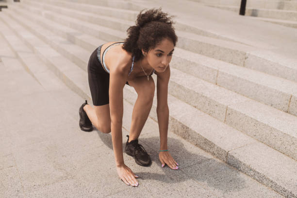 istock Dark-haired slim girl having a workout on the steps outside 1435389918