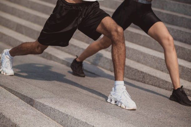istock Close up of two people doing leg lunges together 1435389991