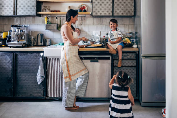 istock Family Preparing Food Together In The Kitchen 1435390507