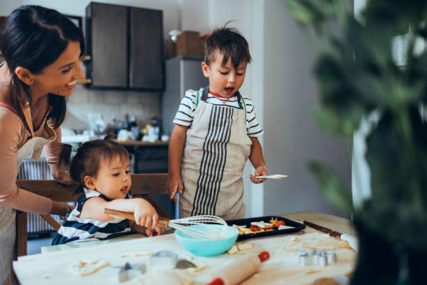 istock Mother And Children Making A Dessert 1435390528