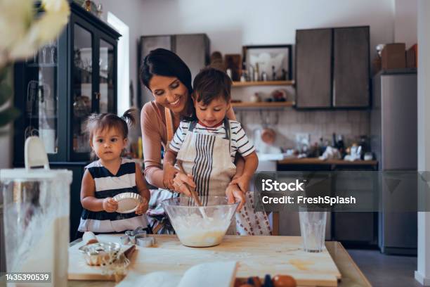 Family Making A Cake Together In The Kitchen Stock Photo - Download Image Now - Cooking, Mother, Baking